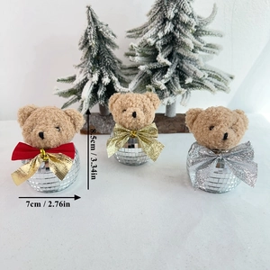 Detailed view of 8.5cm disco ball teddy bear ornaments with festive sequined bows