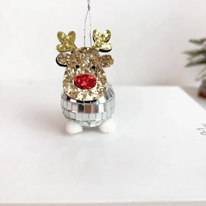 Close-up of a festive golden reindeer disco ball ornament with silver mirror surface