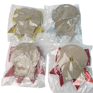 Glittery bow and star festive decorations in gold, silver, pink, and red gift packaging