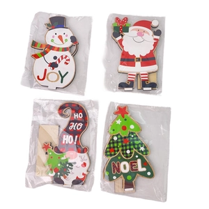 Detailed set of wooden Christmas tabletop ornaments with Snowman and Santa in packaging