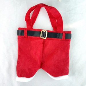 Detail view of Santa Claus trousers gift bag with black belt buckle and white plush trim