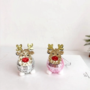 Detail of pink and silver disco ball reindeer ornaments with glittery gold antlers