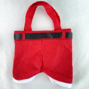 Detail of red felt Santa Claus pants gift bag with black belt and white fur trim