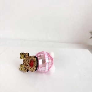 Close-up of pink disco ball reindeer ornament with golden glitter antlers and pom-poms