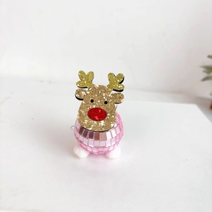 Detail of glitter gold reindeer ornament with pink disco ball base and white pom poms