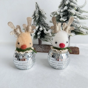 Detail of Christmas reindeer figures with gold antlers and disco ball mirror mosaic bases