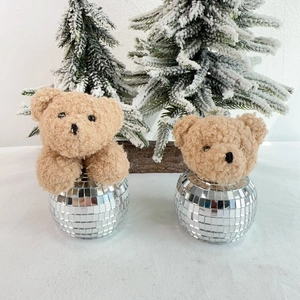Close-up of cute teddy bear heads in silver mosaic disco ball containers for Christmas decor