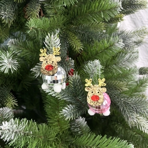 Detailed view of reindeer disco ball ornament hanging on a Christmas tree branch