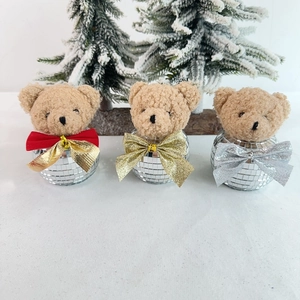 Three disco ball teddy bear ornaments with sparkly bases and festive holiday bows