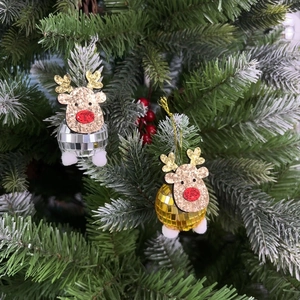 Close-up of glitter reindeer disco ball ornaments hanging on a festive Christmas tree branch