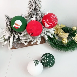 Detail of red and white Christmas baubles with Santa and reindeer on rustic wood