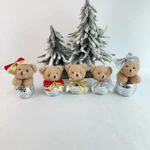 Detail of Christmas disco bear ornaments with reflective mirror tiles and colorful bows