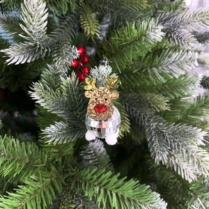 Close-up of golden reindeer disco ball ornament hanging on a festive Christmas tree
