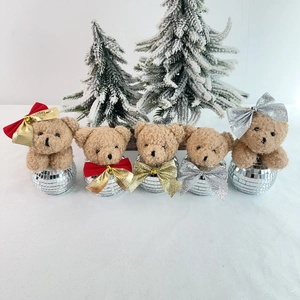 Detail of five brown plush bears with shimmering disco ball bases and festive bows