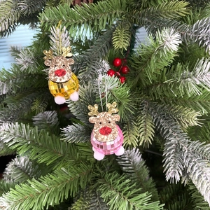 Detail of pink and gold disco ball reindeer ornaments hanging on a Christmas tree branch