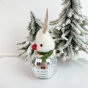 Macro detail of wool felt reindeer ornament on a reflective mirror disco ball base