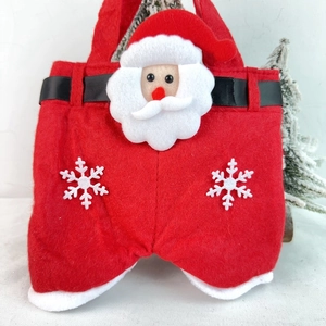 Detail view of red felt Christmas gift bag featuring Santa trousers design and soft handles