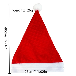 Close-up of red plush Christmas hat with embossed heart patterns and white pom-pom detail