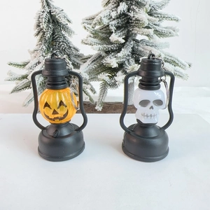 Detail view of retro Halloween lantern pendants featuring pumpkin and skull designs