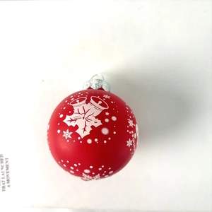Detail of red Christmas ball ornament with white snowflakes and bell pattern decorations
