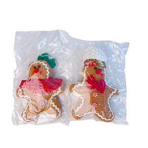 Macro detail of Christmas gingerbread plush figures in protective packaging