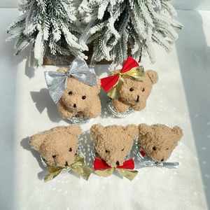 Detail of five mini teddy bear Christmas ornaments with disco ball bases and glitter bows