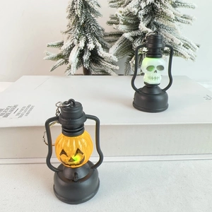 Close-up of lighted Halloween pumpkin and skull lanterns with LED lights and keychains