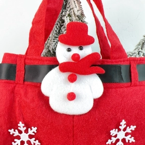 Detail of red Christmas felt gift bag featuring 3D snowman and snowflake embroidery