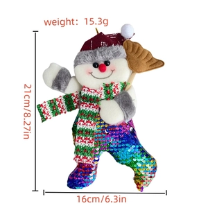 Detail view of snowman Christmas ornament with sparkling colorful sequins and red scarf