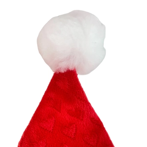 Detail of red plush Christmas hat featuring embossed heart patterns and a white pom-pom