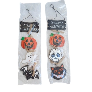Detail of wooden Halloween hanging signs featuring pumpkins, ghosts, and bats with twine