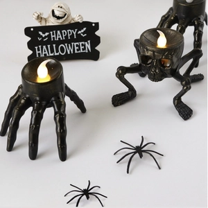 Detail of Halloween LED skeleton hand candle light with decorative small spiders