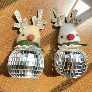 Detail of silver disco ball reindeer ornaments with gold glitter antlers and scarves