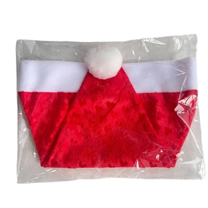 Detailed view of red plush Christmas hat with heart embossing in a clear plastic bag