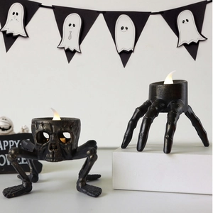 Detail of Halloween skeleton hand and skull LED candle holder for spooky home decor
