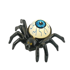 Macro shot of Halloween spider candle light with realistic blue bloodshot eyeball texture