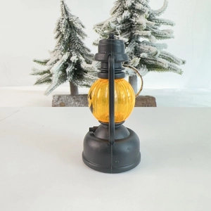 Detail view of mini Halloween pumpkin lantern with black handle and metal keychain hook
