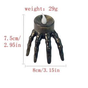 Detail view of Halloween skeleton hand LED candle light with dimensions and gold finish