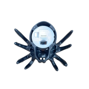 Detailed bottom view of a black spider LED candle light showing switch and battery compartment