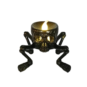 Detailed view of Halloween skull candle lamp with LED flame on white background