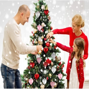 Close-up of sparkling heart-shaped ornaments in varied textures on a Christmas tree