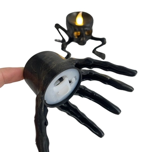 Detailed bottom view of Halloween LED skeleton hand candle showing battery and switch