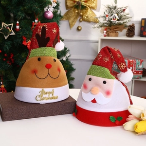 Detail of Christmas hats with reindeer and Santa designs featuring Merry Christmas gold text