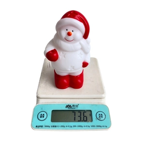 Vue détaillée de la figurine bonhomme de neige lumineux sur balance pesant 73,6g