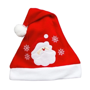 Close-up of Santa Claus embroidery and white snowflake patterns on a red velvet Christmas hat