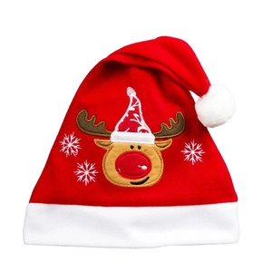 Detailed view of plush red Christmas hat with white reindeer embroidery and snowflakes