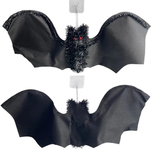 Detail of Halloween bat hanging ornaments with fuzzy texture and red eyes on white background