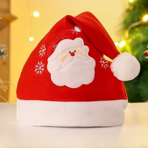 Close-up of velvet Christmas hat with Santa Claus embroidery and soft white plush trim