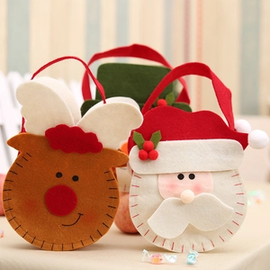 Detail of felt Christmas candy bags featuring Santa Claus and reindeer cartoon designs