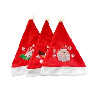 Three Christmas hats with embroidered Santa Claus, reindeer, and snowman designs